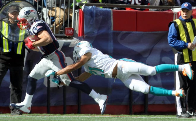 Miami's Brent Grimes, trying to tackle Julian Edelman during a game last season, was in the news this week for all the wrong reasons. Grimes' wife sent out a tweet saying the entire team hates quarterback Ryan Tannehill.