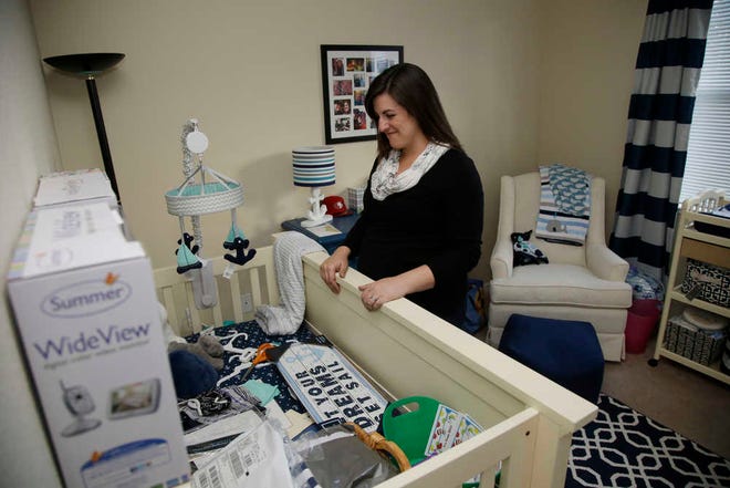 In this Dec. 11, 2015 photo, Katy Howser, a kindergarten teacher in the Santa Clara School District, shows her baby room inside her apartment at Casa Del Maestros, an apartment complex built by the school district for teachers, in Santa Clara, Calif. Howser is expecting her first child. School districts in high cost-of-living areas and rural communities that have long struggled to staff classrooms are considering buying or building rent-subsidized apartments as a way to attract and retain teachers amid concerns of a looming shortage. (AP Photo/Marcio Jose Sanchez)