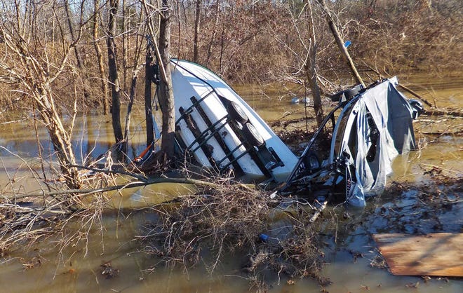 Boats with covers and trailers are fetched up in Meramec River floodwater on Friday, Jan. 1, 2016, just north of Interstate 44 in Eureka, Mo., near Route 66 State Park. The worst of the dangerous, deadly winter flood is over in the St. Louis area, leaving residents of several water-logged communities to spend the first day of 2016 assessing damage, cleaning up and figuring out how to bounce back - or in some cases, where to live. (Jennie Crabbe/St. Louis Post-Dispatch via AP) EDWARDSVILLE INTELLIGENCER OUT; THE ALTON TELEGRAPH OUT; MANDATORY CREDIT