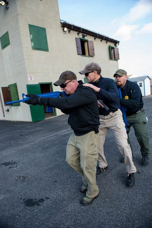 Instructors demonstrate different and safe ways to approach an active shooting scene during training at the Vails Gate Fire Department in New Windsor in December. KELLY MARSH/FOR THE TIMES HERALD-RECORD