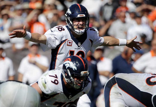 FILE - In this Oct. 11, 2015, file photo, Denver Broncos quarterback Peyton Manning (18) gestures at the line of scrimmage during the first half of an NFL football game against the Oakland Raiders in Oakland, Calif. Manning may have been sidelined for the last half of the season by a foot injury but his legacy was present in all 97 NFL games that have been played during his absence. The league's only five-time MVP was both a throwback and a pioneer in the way he deciphered defenses at the line of scrimmage and served as his own de facto play caller. (AP Photo/Marcio Jose Sanchez, File)
