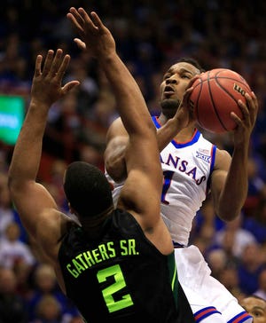 Kansas guard Wayne Selden Jr. (1) drives on Baylor forward Rico Gathers (2) during the first half of an NCAA college basketball game in Lawrence, Kan., Saturday, Jan. 2, 2016. (AP Photo/Orlin Wagner)