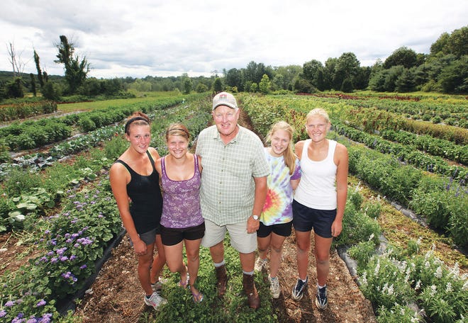 Photo by Daniel Freel/New Jersey Herald -           Charles Kuperus, owner and operator of Kuperus Farmside Gardens and Florist in Sussex Borough, center, poses in this July 2014 photo with his nieces, Janell McDonald, second from left, and Brianna Kuperus, second from right, along with fellow farm employees Megan Gallichio, far left, and Amanda Van Grouw.