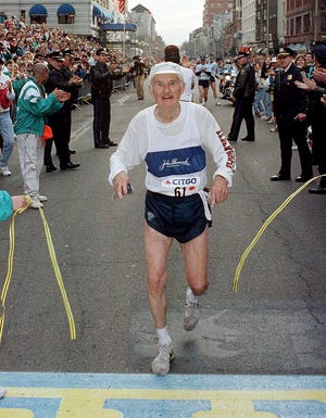 In this April 20, 1992, file photo, Johnny Kelley, 84, crosses the finish line in Boston, during his final running of the Boston Marathon. Kelley, who ran the race 61 times, won it twice. The first feature-length documentary film highlighting historical moments of the nation's oldest marathon is in the works, tentatively set to premiere in April 2017 in conjunction with the 121st running of the race.
