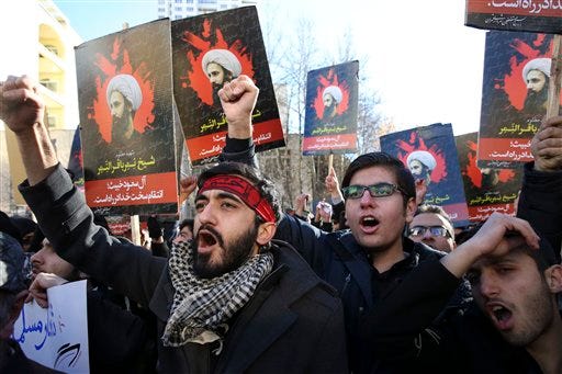 Iranian demonstrators chant slogans during a protest against the execution of Sheikh Nimr al-Nimr, shown in posters, a prominent opposition Shiite cleric in Saudi Arabia, in front of the Saudi Embassy, in Tehran, Sunday, Jan. 3, 2016. Saudi Arabia announced the execution of al-Nimr on Saturday along with 46 others. Al-Nimr was a central figure in protests by Saudi Arabia's Shiite minority until his arrest in 2012, and his execution drew condemnation from Shiites across the region.