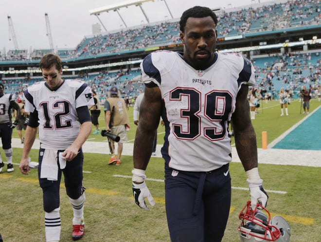 Patriots running back Steven Jackson and quarterback Tom Brady leave the field at the end of a 20-10 loss against the Miami Dolphins on Sunday. With the Patriots loss and the Broncos' win over San Diego, New England will be the No. 2 seed in the AFC. Lynne Sladky/THE ASSOCIATED PRESS