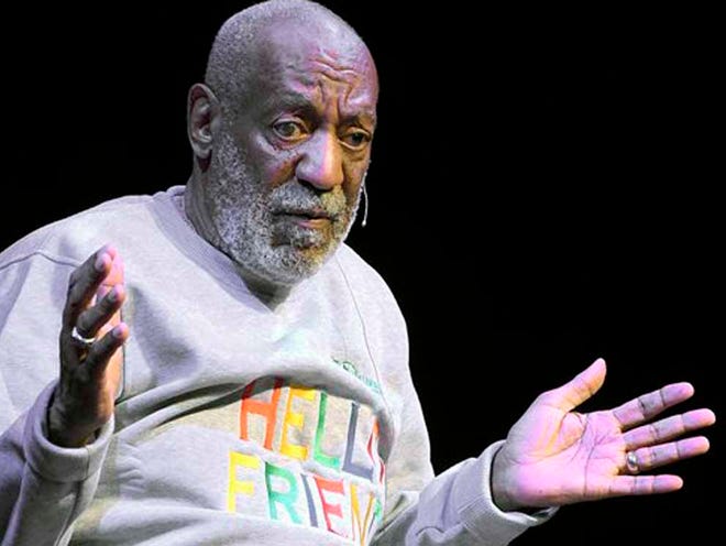 FILE - In this Friday, Nov. 21, 2014, file photo, comedian Bill Cosby performs at the Maxwell C. King Center for the Performing Arts, in Melbourne, Fla. Lawyers for Cosby say they will fight an attempt to require the comedian's wife to give a sworn deposition in a defamation lawsuit filed by seven women who have accused Cosby of sexually assaulting them decades ago. A lawyer for the women has subpoenaed Camille Cosby to be deposed on Jan. 6, 2016, at a Springfield hotel.