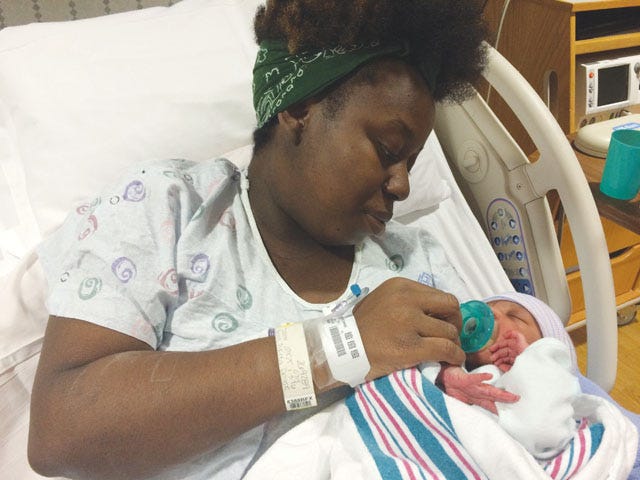 Taketa Brown holds her daughter, Imani Brown, the first baby born in Lenoir County in 2016.