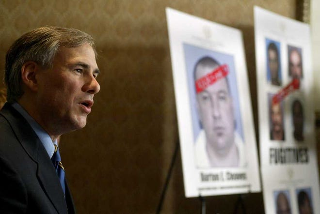 In this Oct. 10, 2003 photo, Texas Attorney General Greg Abbott announced the arrest of nine fugitive sex offenders on parole violations by the newly formed Fugitive Unit, while speaking at a press conference in Dallas, Texas. During his 14 years as Texas' top lawyer, Abbott oversaw a significant and expensive escalation of police and firepower in the attorney general's office, which now boasts 160 cops and an arsenal of assault rifles, handguns and tactical gear. (Ron Baselice/The Dallas Morning News via AP) MANDATORY CREDIT