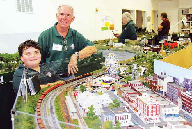 Eight-year-old Rama Ball, the youngest member of the Knoxville Area Model Railroaders, and Larry Burkholder enjoy the trains and layout in one of the Railroaders’ club rooms at the Children’s Museum of Oak Ridge.
