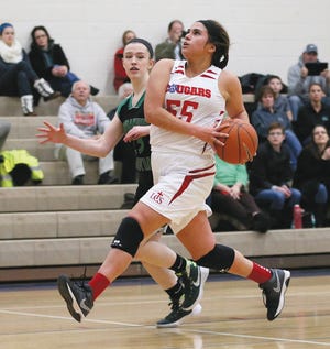 Lenawee Christian junior Kiara Nieto gets ready to go up for a layup against Emmanuel Christian junior Melissa Watkins during their game Monday. Nieto finished with a game-high 19 points. Telegram photo by Mike Dickie