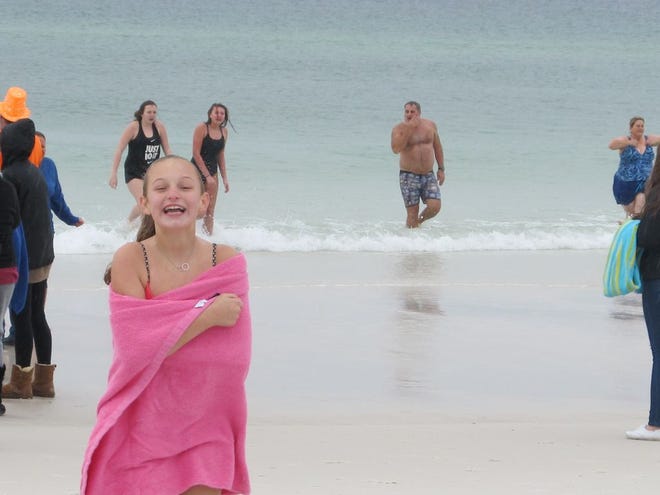 A young girl laughs after plunging into the Gulf of Mexico in Destin on New Year's Day.