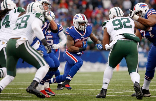 Buffalo Bills running back Mike Gillislee tries to avoid a tackle by New York Jets defensive end Leonard Williams (92) on Sunday.
