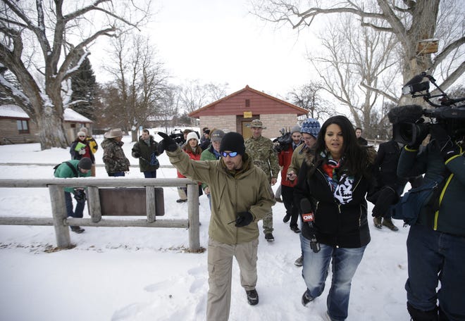 A member of the group occupying the Malheur National Wildlife Refuge headquarters conducts a tour with the media Monday, Jan. 4, 2016, near Burns, Ore. The group calls itself Citizens for Constitutional Freedom and has sent a "demand for redress" to local, state and federal officials. Ammon Bundy told reporters on Monday that two local ranchers who face long prison sentences for setting fire to land have been treated unfairly. The armed anti-government group took over the remote national wildlife refuge in Oregon as part of a decades-long fight over public lands in the West. (AP Photo/Rick Bowmer)