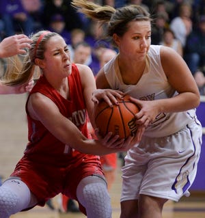Brandi Bisping of Morton, left, tries to pull the ball away from Sydnie Wells of Canton during Tuesday's game at Ingersoll Gym in Canton.
