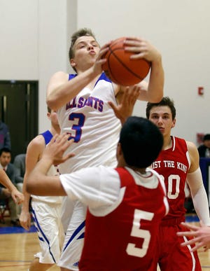 All Saints player Ben Tipton rebounds the ball during the Patriots' game against Christ the King on Tuesday, Jan. 5, at Patriot Gym in Lubbock.
