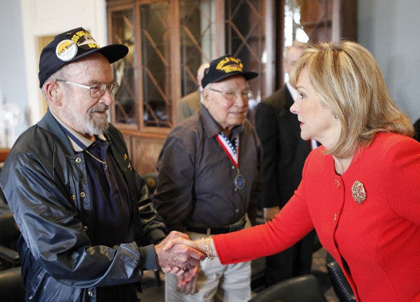 World War II veterans Edward E. Vezey Jr., left, and Choc Charleston are greeted by Gov. Mary Fallin during a news conference on March 21, 2011. Vezey, 96, died Saturday in Moore. He is believed to have been the last surviving crewman living in Oklahoma who served on the USS Oklahoma. [The Oklahoman Archives]