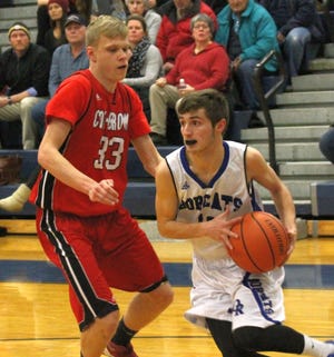 Oyster River's Griffin Luczek, right, tries to drive past Coe-Brown's Jacob Snow during Division II action Tuesday night in Durham. Al Pike/fosters.com