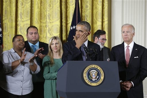 President Barack Obama, joined by Vice President Joe Biden and gun violence victims, wipes a tear from his cheek as speaks in the East Room of the White House in Washington, Tuesday, Jan. 5, 2016, about steps his administration is taking to reduce gun violence. Also on stage are stakeholders, and individuals whose lives have been impacted by the gun violence. (President Barack Obama, joined by Vice President Joe Biden and gun violence victims, wipes a tear from his cheek as speaks in the East Room of the White House in Washington, Tuesday, Jan. 5, 2016, about steps his administration is taking to reduce gun violence. Also on stage are stakeholders, and individuals whose lives have been impacted by the gun violence.
