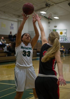 Manteca's Leah Manulelua attempts a shot over Patterson's Hailey Hansen in a second-round game of the Tracy Breakfast Lions/Tom Hawkins girls basketball tournament last month at Tracy High. Manulelua and the Buffaloes begin Valley Oak League play today. CLIFFORD OTO/RECORD FILE 2015