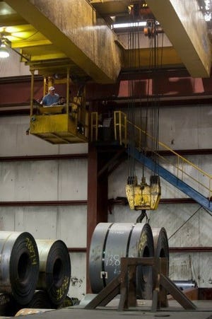A crane operator lifts a steel coil in the Portage Feralloy facility in 2012. Great Lakes steel production rose by 2.4 percent in the week that ended on the first Saturday in 2016.