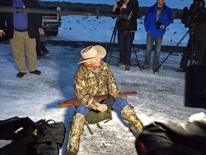 Arizona rancher LaVoy Finicum, holding rifle, speaks to reporters at the Malheur National Wildlife Refuge, Tuesday, Jan. 5, 2016, near Burns, Ore. Ammon Bundy, the leader of a small, armed group that is occupying a remote national wildlife preserve in Oregon said Tuesday that they will go home when a plan is in place to turn over management of federal lands to locals. (AP Photo/Rebecca Boone)