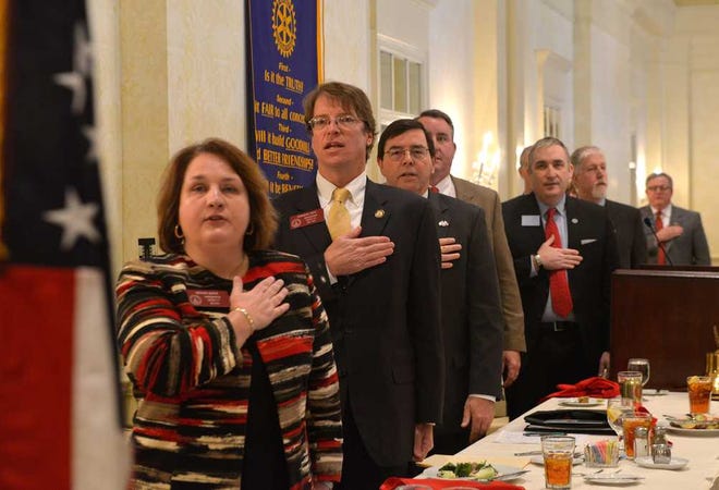 State and local officials salute the flag during the pledge at a pre-legislative forum at the Athens Country Club sponsored by the Athens Rotary Club and the Classic City Rotary Club on Wednesday, Jan. 6, 2016. (Richard Hamm/Staff) OnlineAthens / Athens Banner-Herald