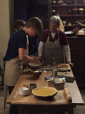 During a workshop at Wheelwright House at Strawbery Banke Museum, participants learn to cook a meal as residents of the area would have in the 19th Century at the hearth in their home. Courtesy photo