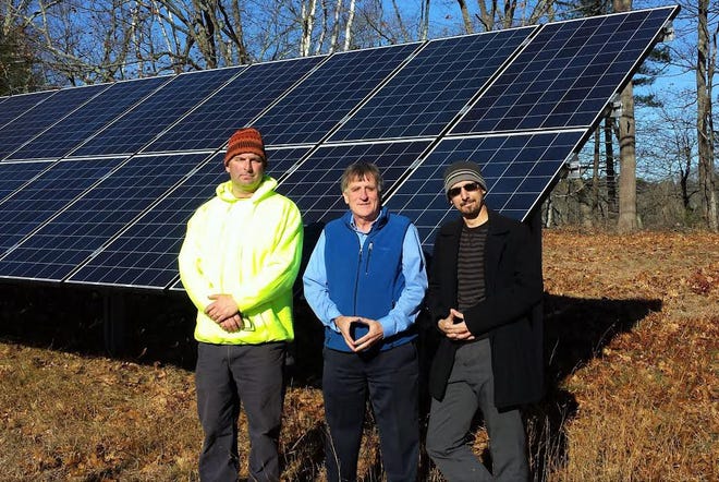 From left, Facilities Manager John Speight, Wells Reserve Director Paul Dest, and Laudholm Trust President Nik Charov at one of the solar panel arrays providing electrical power at Laudholm Farm.

Photo by Jim Kanak