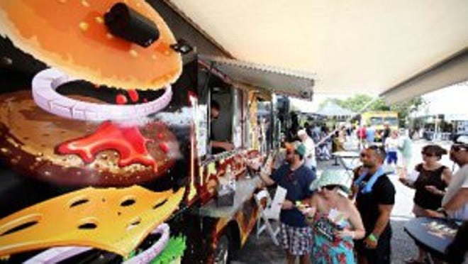 Customers line up for Munchie's Snack Shack during the Gourmet Pig Out at the PGA National Resort and Spa in Palm Beach Gardens.