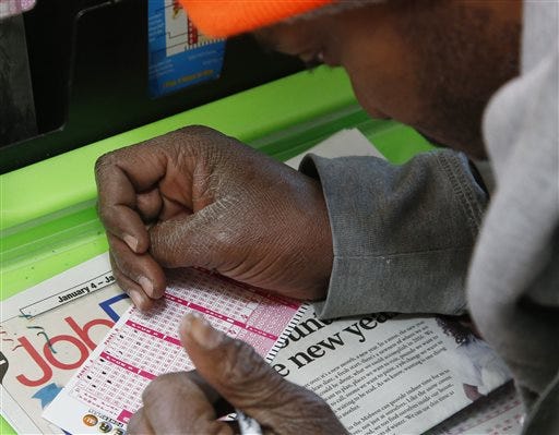 Jermaine Emory Mallory fills out a Powerball number selection slip at a store in Oklahoma City, Tuesday, Jan. 5, 2016. The estimated Powerball jackpot for Wednesday night has soared to $450 million. No one has won the big prize in two months and officials say the jackpot is now the sixth-largest ever in North America. Players will have a chance Wednesday night at the biggest lottery prize in nearly a year. The last time Powerball had grown this large was in February 2015, when three winners split a $564.1 million prize.
