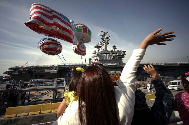 Family members of sailors wave Oct. 1, 2015, as the U.S. Navy aircraft carrier USS Ronald Reagan arrives at a U.S. Navy base in Yokosuka, Japan south of Tokyo. The U.S. Pacific Fleet is smaller than it was in the 1990s, helping fuel a debate about whether the U.S. has enough ships to meet challenges posed by fast-growing and increasingly assertive Chinese naval forces.