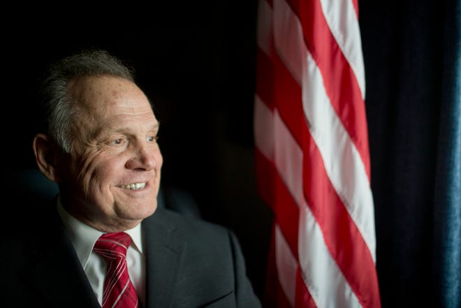n this photo taken on Tuesday, Feb. 17, 2015, Alabama Chief Justice Roy Moore poses in front the the American flag, in Montgomery, Ala. The chief justice continues to fight against gay marriage in Alabama. Moore told state probate judges to refuse the marriage licenses to gay couples, saying they weren't bound to adhere to the ruling of the federal judge who declared Alabama's gay marriage ban unconstitutional. Moore said decision legalizing gay marriage would be among the court's greatest mistakes. (AP Photo/Brynn Anderson)