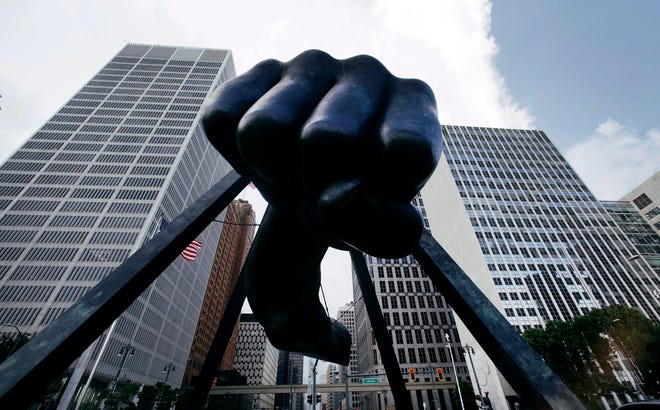 In this July 18, 2013, file photo, the Detroit skyline rises behind the Monument to Joe Louis, also known as "The Fist." The Associated Press