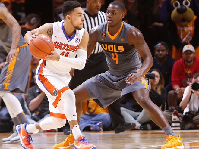 Florida's Chris Chiozza looks to pass under pressure from Tennessee's Armani Moore on Wednesday in Knoxville, Tenn.