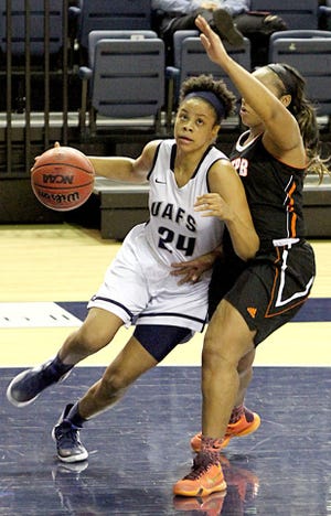 Jamie Mitchell • Times Record UAFS' Maya Perry drives the baseline around the UTPB defender, Saturday, Jan 02, 2016, during first half play at the Stubblefield Center. 
 BRIAN D. SANDERFORD • TIMES RECORD UAFS’ Ashley Bean, left, shoots as St. Edwards’ Essence Sauls guards during the first half on Thursday, Dec. 31, 2015 in the Stubblefield Center.