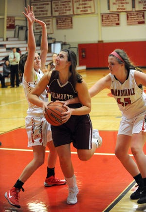 Taylor Miller of Falmouth tries to get through the defense of Barnstable's Carly Whiteside, right, and Megan Dombrowski in Friday night's high school action in Hyannis. Falmouth won, 39-35. For a photo gallery, go online to CapeCodTimes.com/photos. Ron Schloerb/Cape Cod Times