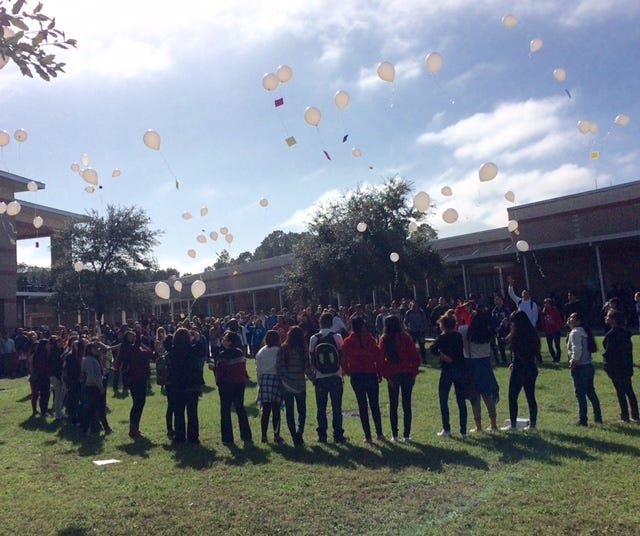 Students and teammates release balloons at Taylor-Middle High School on Thursday in memory of Rosio Delao, 16, who collapsed and died during a junior varsity game.