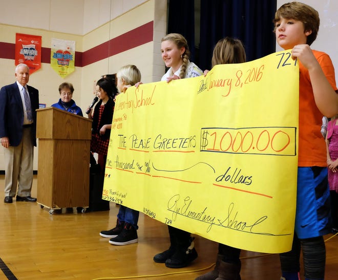 Members of the Rye Elementary School student council present members of the Pease Greeters' Board of Directors, David Frye and JoAnne Schottler, a check for $1,000 during a school assembly on Friday.

Photo by Ioanna Raptis/Seacoastonline
