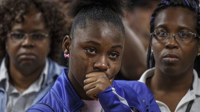 Jamia Jordan weeps during a singing performance at the ceremony for the newly dedicated Gloria J. Riley Drivers Lounge at Palm Beach County School District’s central bus depot in West Palm Beach on Friday, January 8, 2016. Riley was Jordan’s grandmother. (Thomas Cordy / The Palm Beach Post)