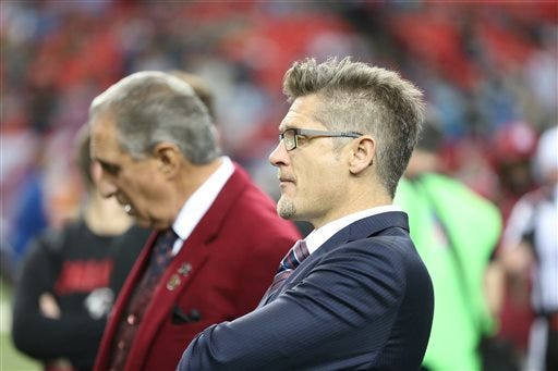 In this Dec. 27, 2015, file photo, Atlanta Falcons General Manager Thomas Dimitroff, right, stands next to Falcons owner Arthur Blank before the first half of an NFL football game against the Carolina Panthers in Atlanta. Blank says he is sticking with general manager Thomas Dimitroff, who he says has formed a productive management team with first-year coach Dan Quinn. Blank said Friday there will be changes in the pro personnel and scouting departments. (AP Photo/John Bazemore, File)