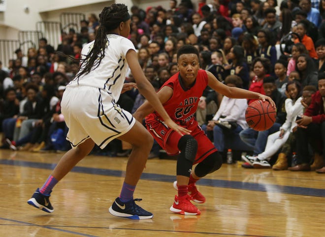Central's Antiyocka Howard (20) dribbles the ball guarded by Bryant's Iesha Menda (12) during a ladies basketball game held at Paul W. Bryant High School in Tuscaloosa, Ala. on Friday Jan. 8, 2016.  staff photo | Erin Nelson