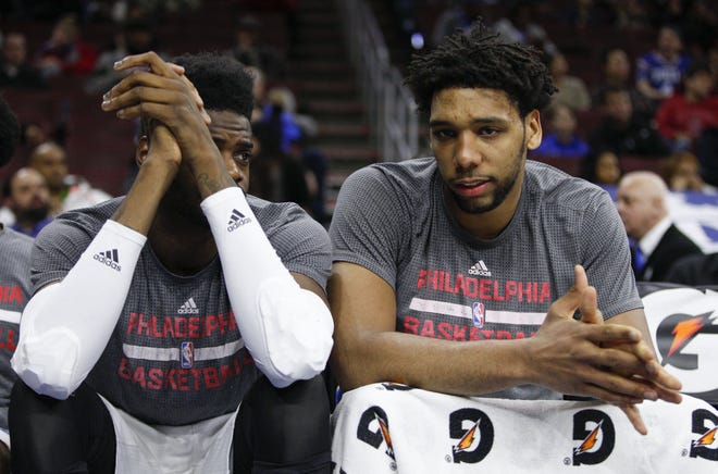 (File) The 76ers' Nerlens Noel (left) and Jahlil Okafor chat on the bench during the fourth quarter of a January 2016 home loss to the Hawks.