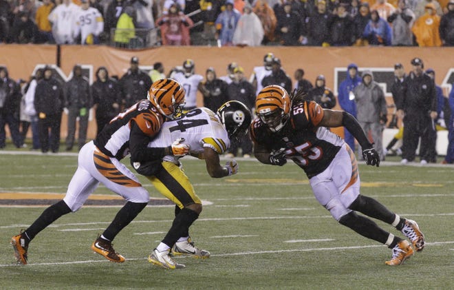 Cincinnati's Vontaze Burfict (55) runs into Pittsburgh's Antonio Brown (84) during the second half of an NFL wild-card playoff game Saturday in Cincinnati. Burfict was called for a penalty on the play. ASSOCIATED PRESS/JOHN MINCHILLO
