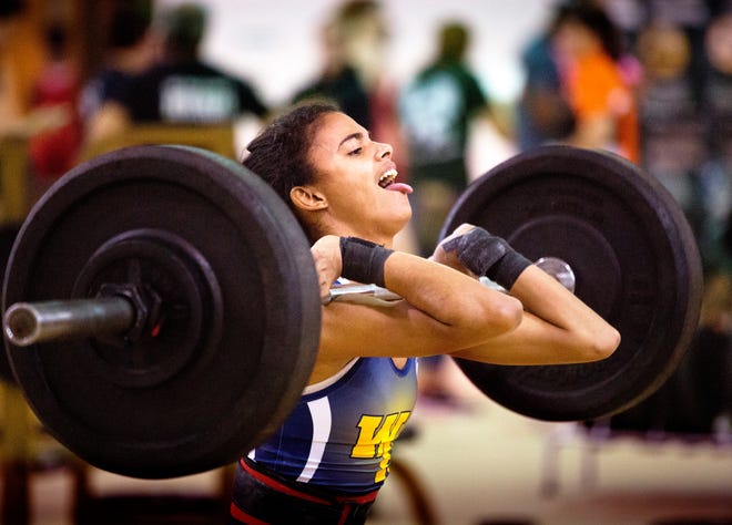 Winter Haven's Greta Galarza Rodriguez gets under a 145-pound clean-and-jerk lift during the Polk County Girls Weightlifting Championships at George Jenkins on Saturday.