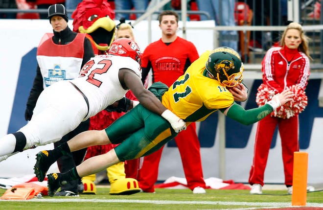 North Dakota State quarterback Carson Wentz dives for a touchdown as Jacksonville State defensive lineman Desmond Owino tries to tackle him during the first half of the FCS championship game on Saturday in Frisco, Texas. (AP Photo/Mike Stone)