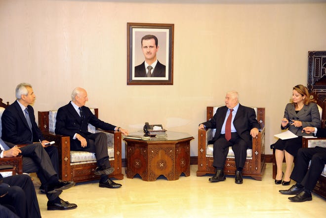 In this photo released by the Syrian official news agency SANA, Syria's Foreign Minister Walid al-Moallem, second right, meets with U.N. Special Envoy for Syria Staffan de Mistura, second left, in Damascus, Syria, Saturday, Jan. 9, 2016. Syria is ready to attend peace talks later this month in Geneva but the government wants to see lists of the opposition groups who will attend and ensure that "terrorist" groups that will not, the country's foreign minister said Saturday according to SANA. (SANA via AP)