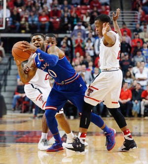 Kansas's Frank Mason III looks for an open teammate late in the second period of an NCAA college basketball game Saturday, Jan. 9, 2016, in Lubbock, Texas. (AP Photo/Mark Rogers)