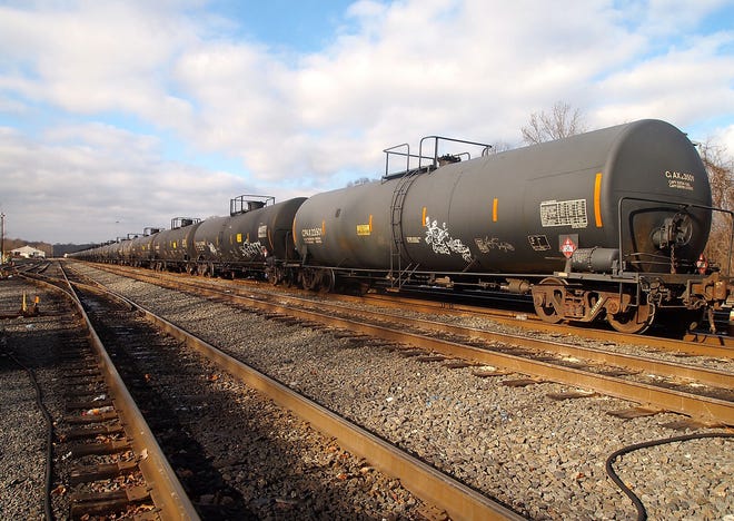 A long train of tank cars, marked to carry hazardous materials such as crude oil and other flammable liquids, sits in Norfolk Southern's Abrams Yard in Upper Merion.