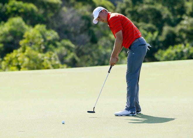 Jordan Spieth watches his eagle putt go in on the 18th green during the third round of the Tournament of Champions golf tournament, Saturday, Jan. 9, 2016, at Kapalua Plantation Course on Kapalua, Hawaii. (AP Photo/Matt York)